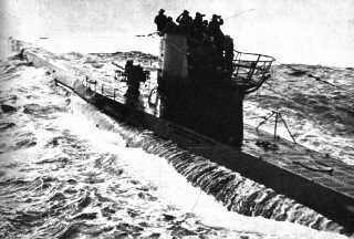 Water streams down from beneath the outer hull of a Type VII U-boat.