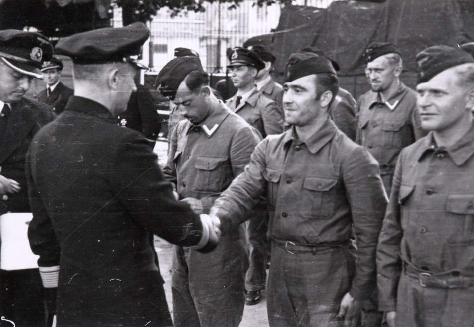 Donitz greets the returning U-boat crew after a war patrol.